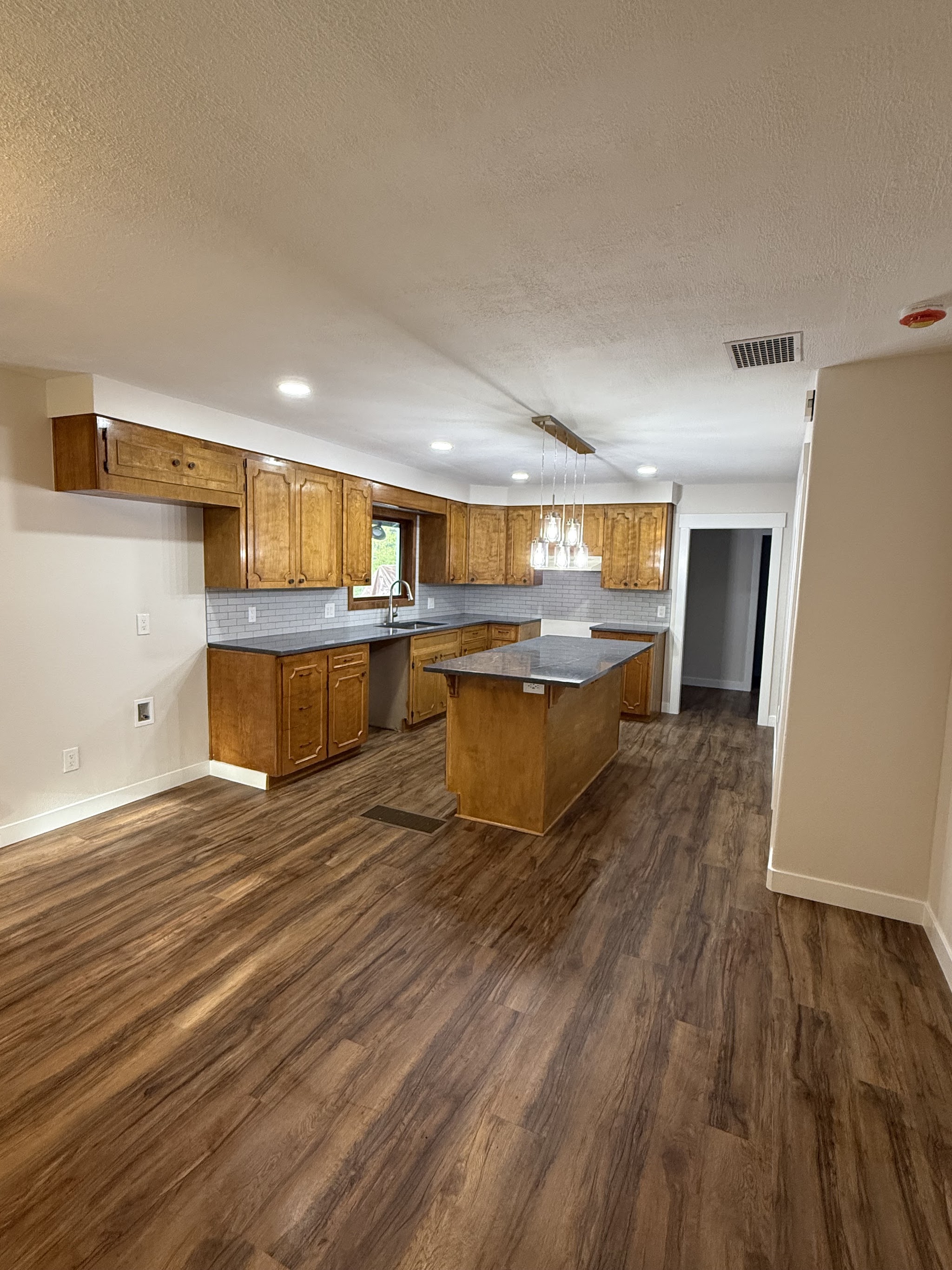 New luxury vinyl plank flooring installed in a kitchen by Castor's Flooring